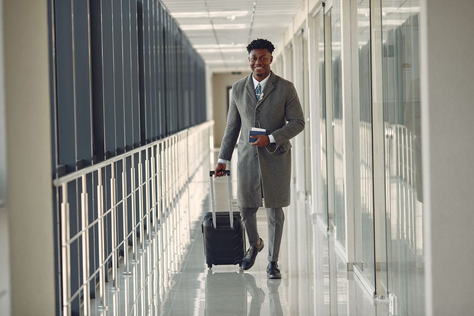 Forretningsrejsende går gennem en lys terminal med håndbagage